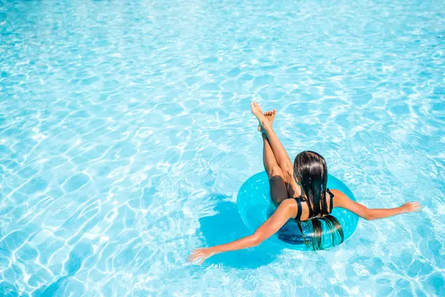 little adorable girl in outdoor swimming pool